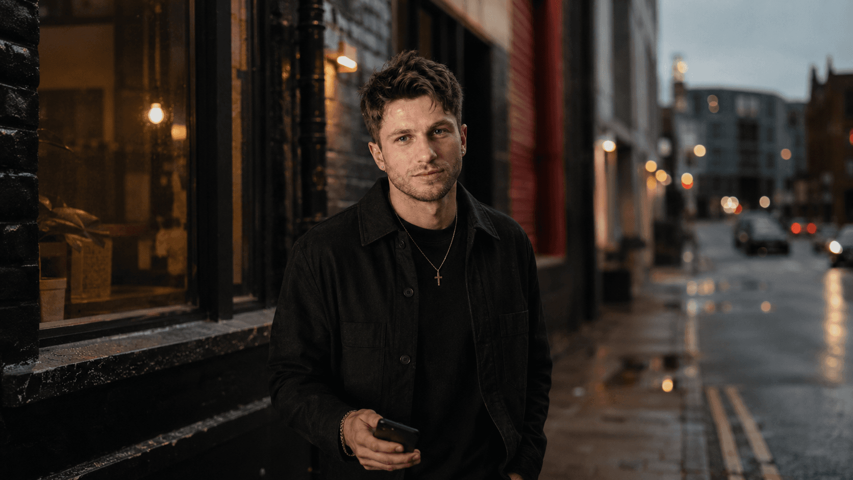 Ged Armstrong standing on a Belfast street at dusk.