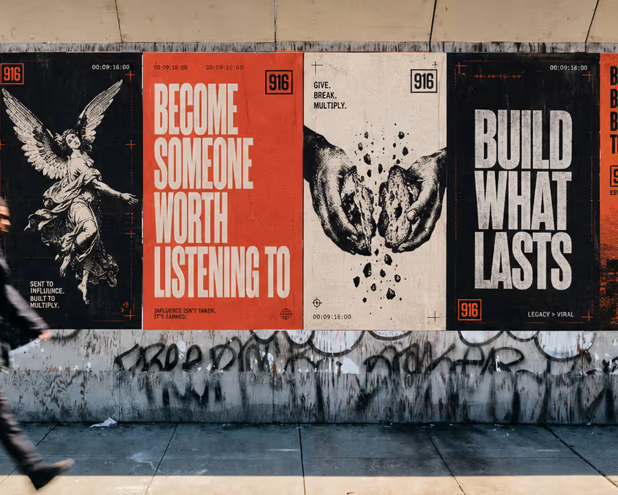 Concept study showing a The916 poster campaign across a public wall as a pedestrian walks past.